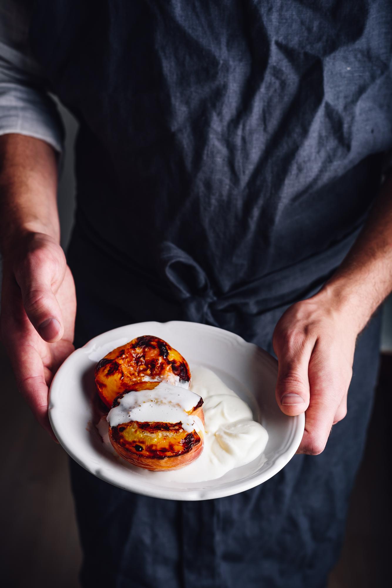 Closeup of hands plating a dessert